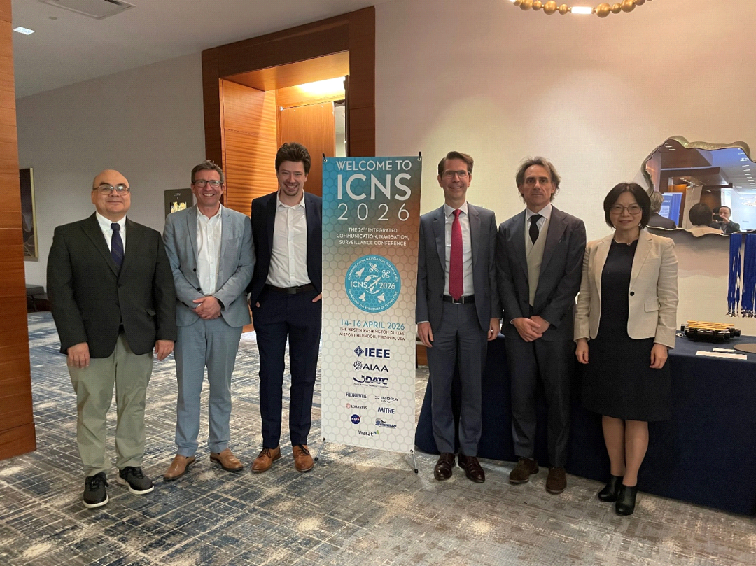 Plenary IV participants pose together on stage near the ICNS 2026 session screen.