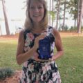 Denise Ponchak holding the 2020 ICNS Champion Award