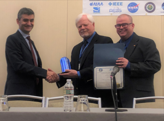 Chris Wargo (center), with 2019 Conference General Chair Dr. Nikos Fistas and Award Chair Tom Redling. 